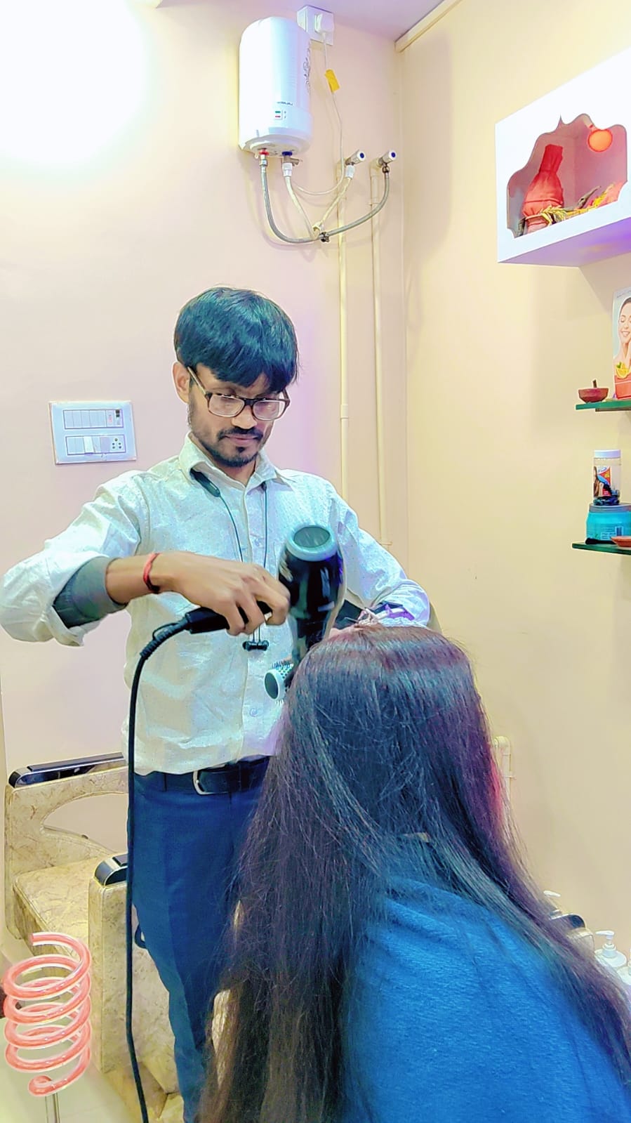 Male stylist working on a client hair styling session